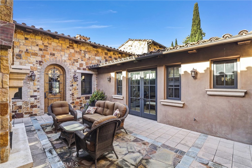 41 Needle Grass Irvine, CA 92603 - Photo 47 of 64 a view of a patio with couches table and chairs and potted plants