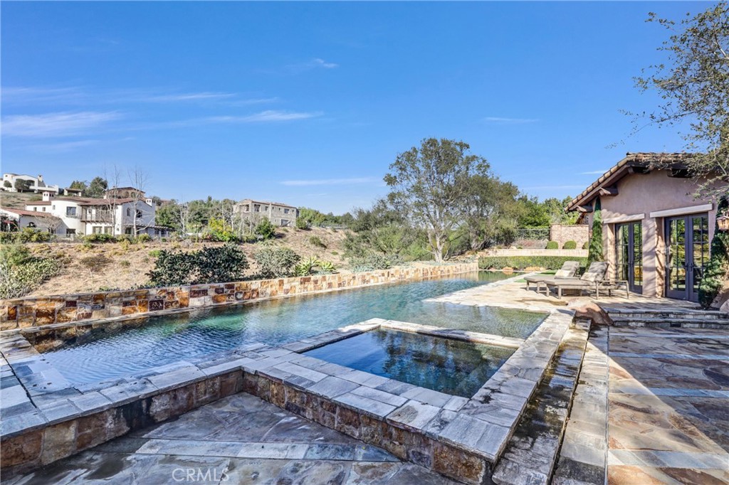 41 Needle Grass Irvine, CA 92603 - Photo 49 of 64 a view of a swimming pool with a lounge chair