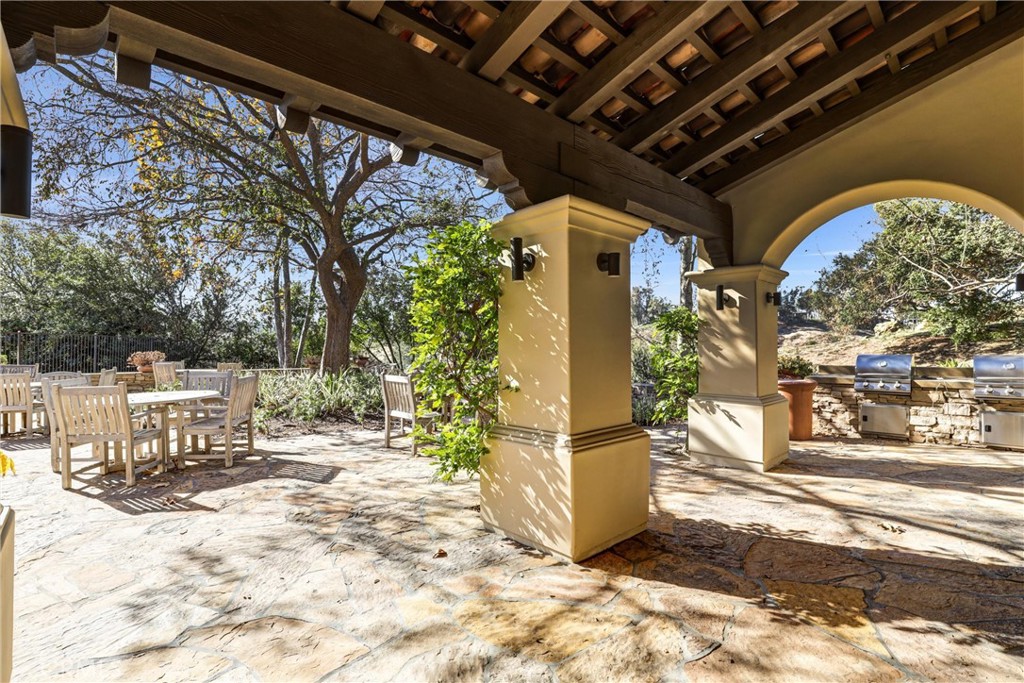 41 Needle Grass Irvine, CA 92603 - Photo 56 of 64 a view of a porch with table and chairs and potted plants
