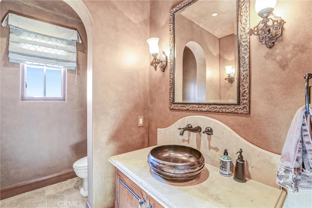 41 Needle Grass Irvine, CA 92603 - Photo 10 of 64 a bathroom with a toilet a sink and a mirror