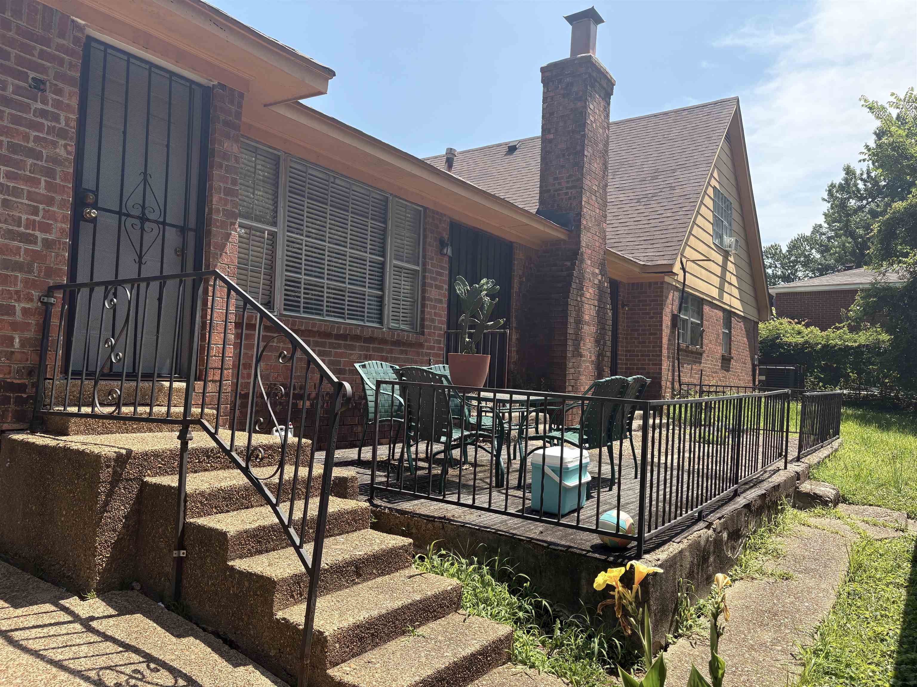4009 Tessland Road Memphis, TN 38128 - Photo 13 of 16 Rear exterior featuring a brick facade and a raised wooden deck with black metal railing