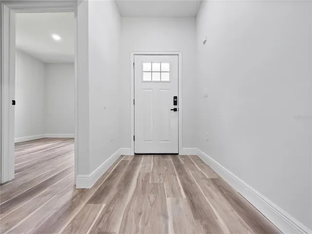 a view of wooden floor and window in a room