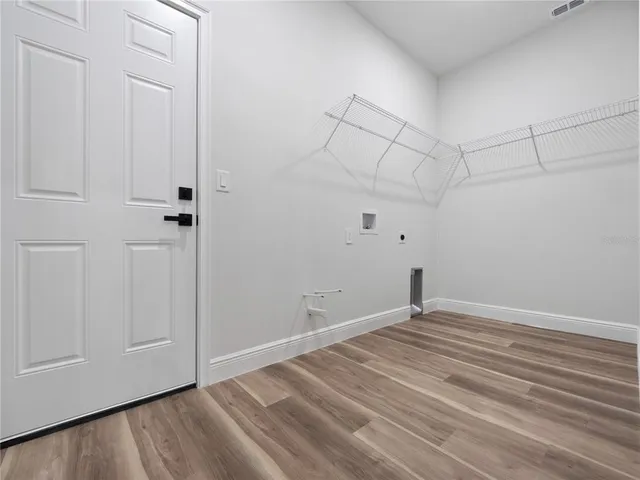 a view of a room with wooden floor