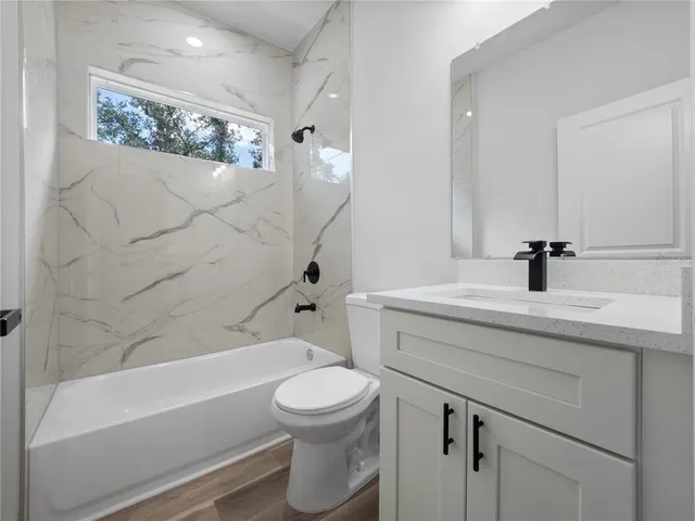 a bathroom with a sink a toilet and a bathtub