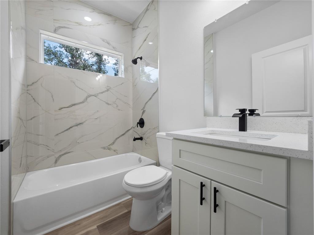 3310 Southwest 177th Lane Road Ocala, FL 34473 - Photo 20 of 40 a bathroom with a sink a toilet and a bathtub