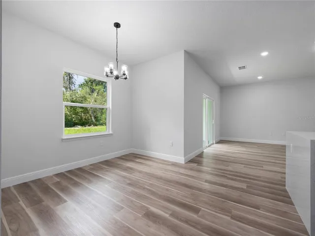 a view of room with window and hardwood floor