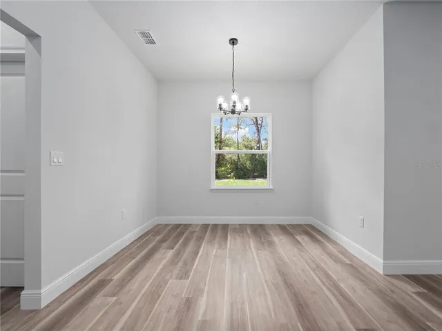 a view of room with window and hardwood floor