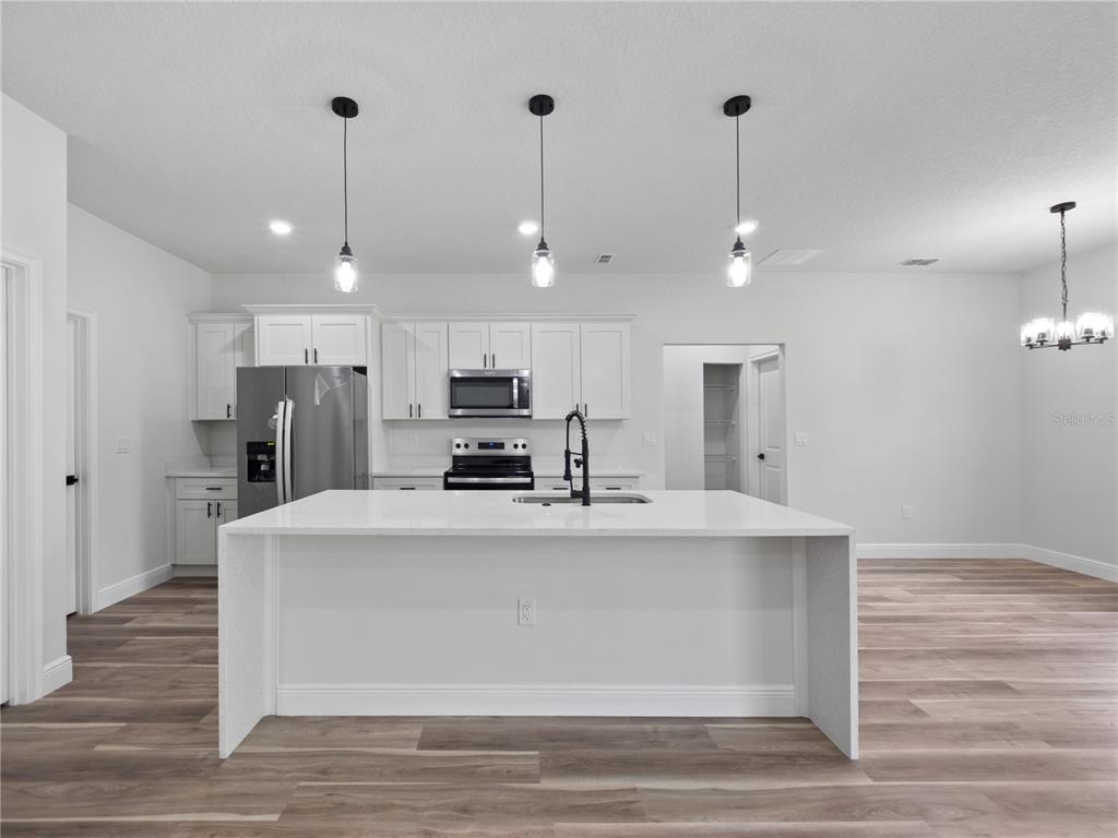 3310 Southwest 177th Lane Road Ocala, FL 34473 - Photo 26 of 40 a large white kitchen with stainless steel appliances