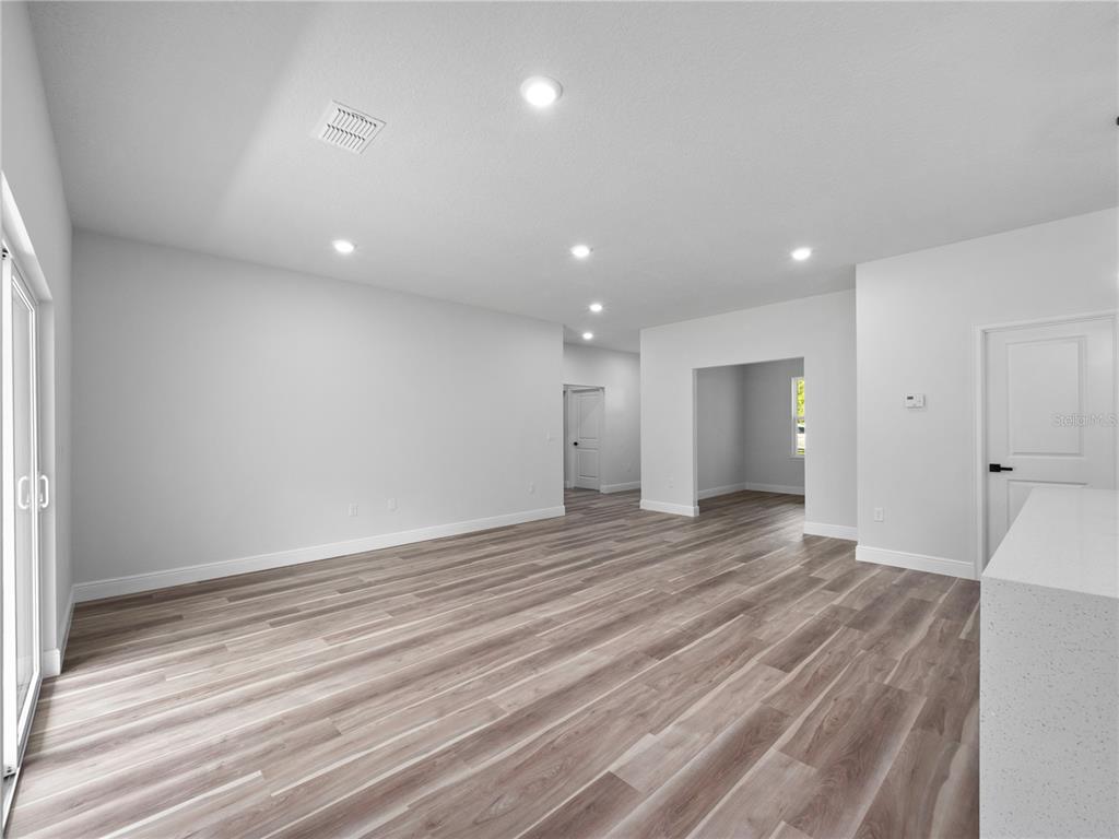 3310 Southwest 177th Lane Road Ocala, FL 34473 - Photo 29 of 40 an empty room with wooden floor and natural light