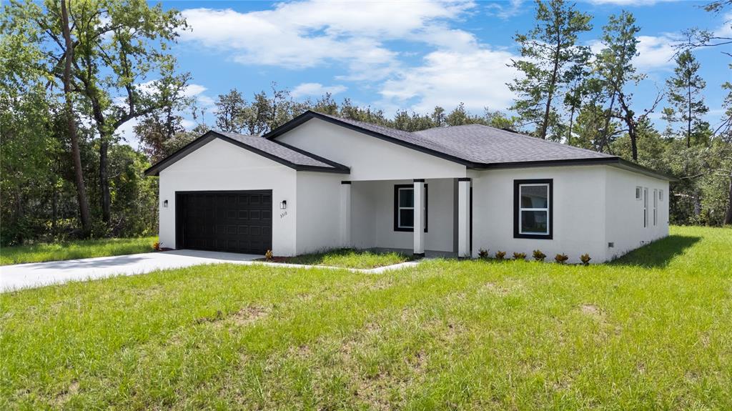 3310 Southwest 177th Lane Road Ocala, FL 34473 - Photo 33 of 40 a view of a house with a yard