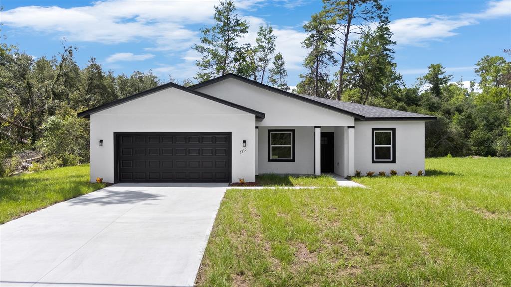 3310 Southwest 177th Lane Road Ocala, FL 34473 - Photo 35 of 40 a front view of house with yard and green space