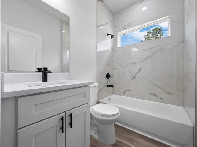 a bathroom with a sink a toilet and a bathtub