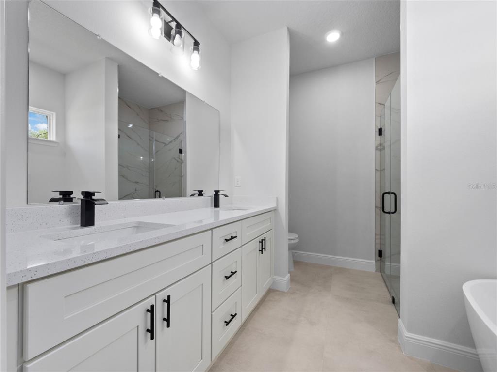 3310 Southwest 177th Lane Road Ocala, FL 34473 - Photo 7 of 40 a bathroom with double sink and a mirror