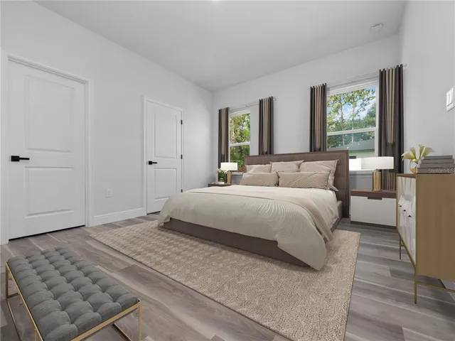 a bedroom with a large bed and a window