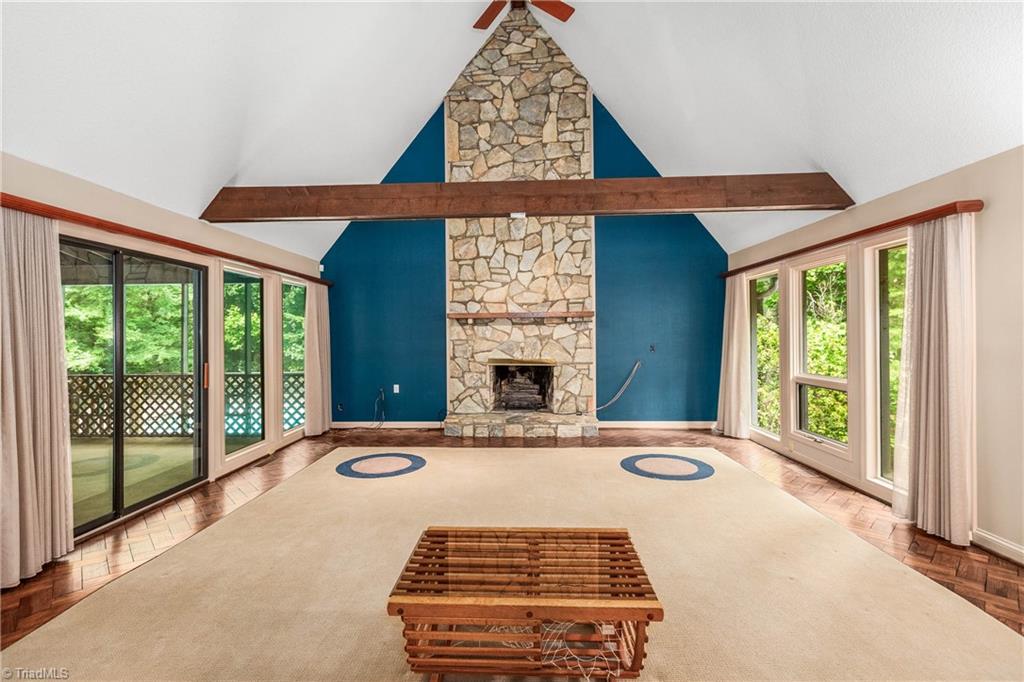 4200 Clinard Road Clemmons, NC 27012 - Photo 10 of 49 Large family room with wooden beams, stone fireplace, and plenty of light! Glass doors to screened in porch.