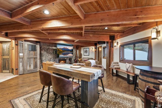 2687 Stewart Road Sundance, UT 84604 - Photo 21 of 48 Dining room with a wood ceiling with exposed beams, a stone fireplace, wood finished floors, and recessed lighting
