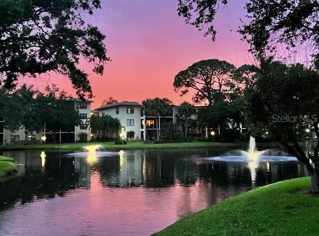 a lake view with a garden and trees