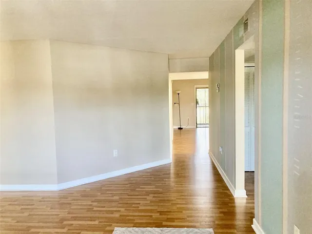 a view of a hallway with wooden floor