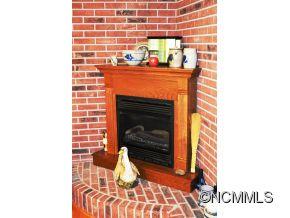118 Riverside Drive Canton, NC 28716 - Photo 13 of 21 a fireplace with a clock on wall