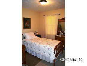 118 Riverside Drive Canton, NC 28716 - Photo 19 of 21 a bedroom with a bed and a view of bathroom
