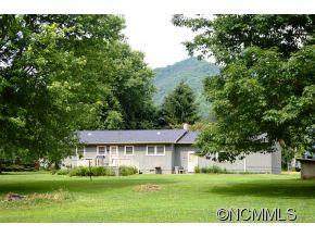 118 Riverside Drive Canton, NC 28716 - Photo 7 of 21 a view of a big house with a big yard and large trees