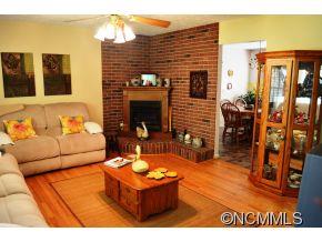 118 Riverside Drive Canton, NC 28716 - Photo 8 of 21 a living room with furniture a flat screen tv and a fireplace