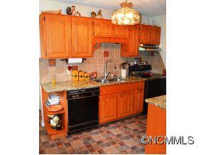 118 Riverside Drive Canton, NC 28716 - Photo 9 of 21 a kitchen with stainless steel appliances granite countertop a stove a sink and a microwave