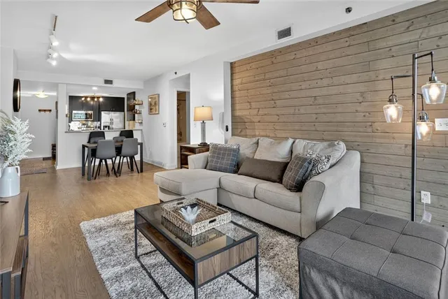a living room with furniture and wooden floor