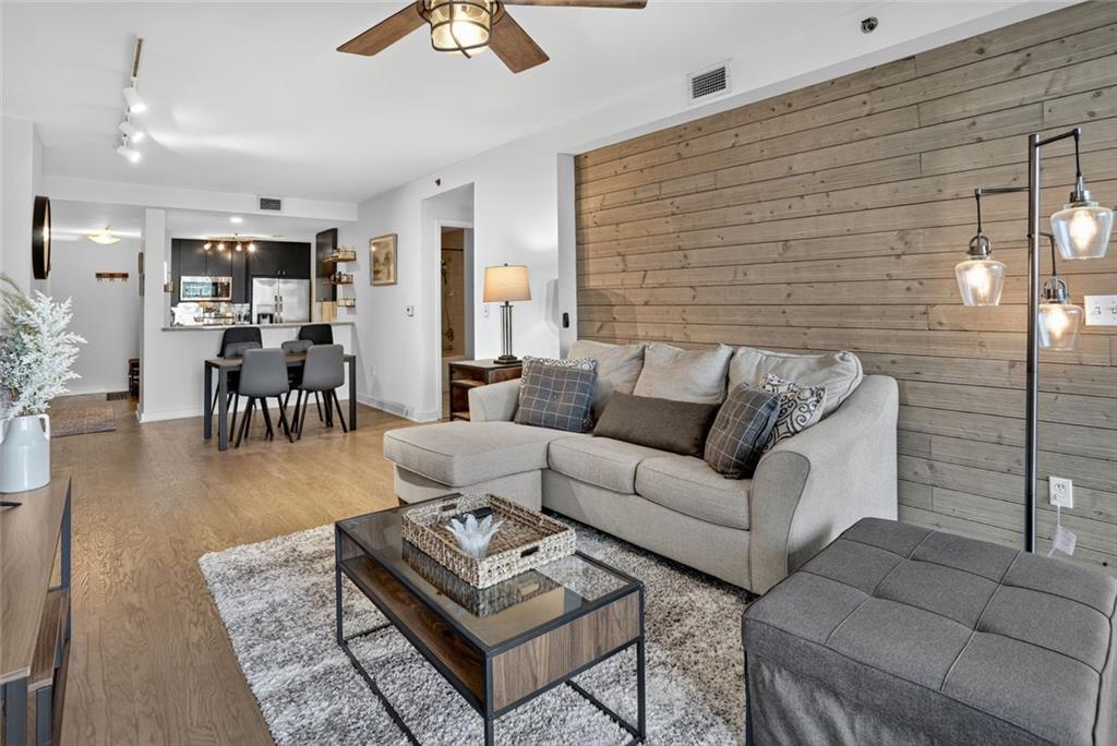 3338 Peachtree Road Northeast, Unit 1706 Atlanta, GA 30326 - Photo 1 of 35 a living room with furniture and wooden floor