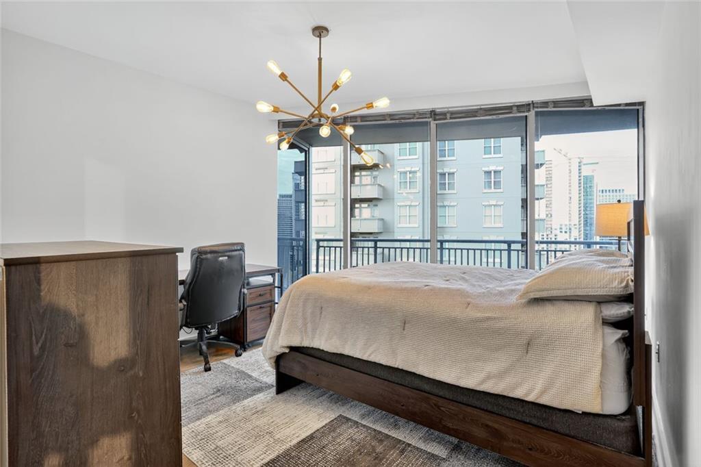 3338 Peachtree Road Northeast, Unit 1706 Atlanta, GA 30326 - Photo 11 of 35 a bed sitting in a bedroom next to a window