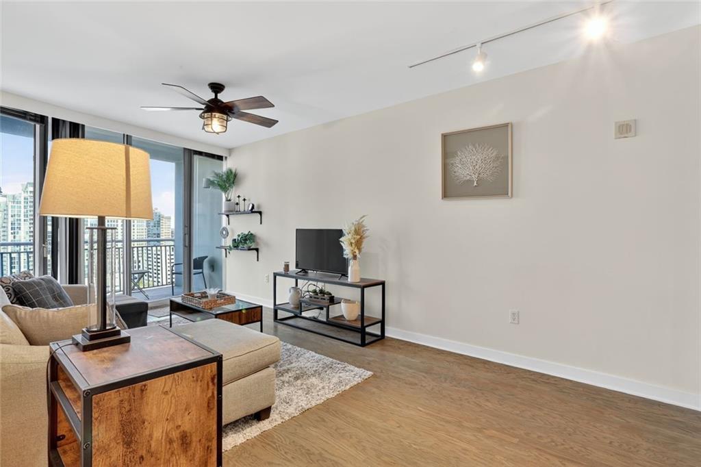 3338 Peachtree Road Northeast, Unit 1706 Atlanta, GA 30326 - Photo 2 of 35 a living room with furniture a flat screen tv and a window
