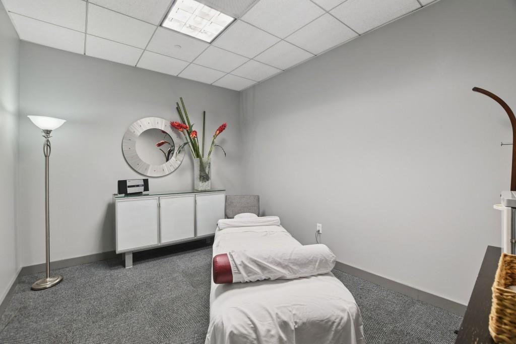 3338 Peachtree Road Northeast, Unit 1706 Atlanta, GA 30326 - Photo 28 of 35 a bedroom with a bed and a chandelier