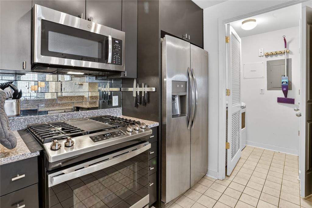 3338 Peachtree Road Northeast, Unit 1706 Atlanta, GA 30326 - Photo 4 of 35 a kitchen with stainless steel appliances granite countertop a stove microwave and refrigerator