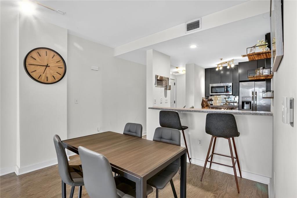 3338 Peachtree Road Northeast, Unit 1706 Atlanta, GA 30326 - Photo 6 of 35 a view of a dining room with furniture and wooden floor