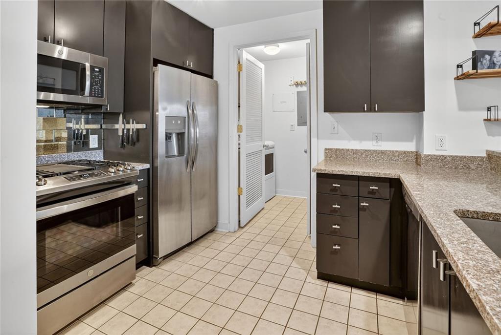 3338 Peachtree Road Northeast, Unit 1706 Atlanta, GA 30326 - Photo 7 of 35 a kitchen with granite countertop a refrigerator and a stove