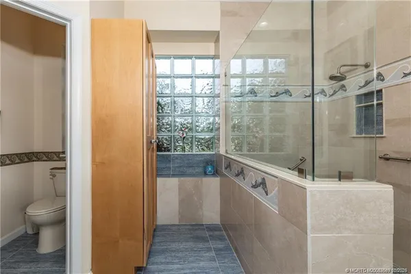 a view of a table and chairs in patio with a backyard