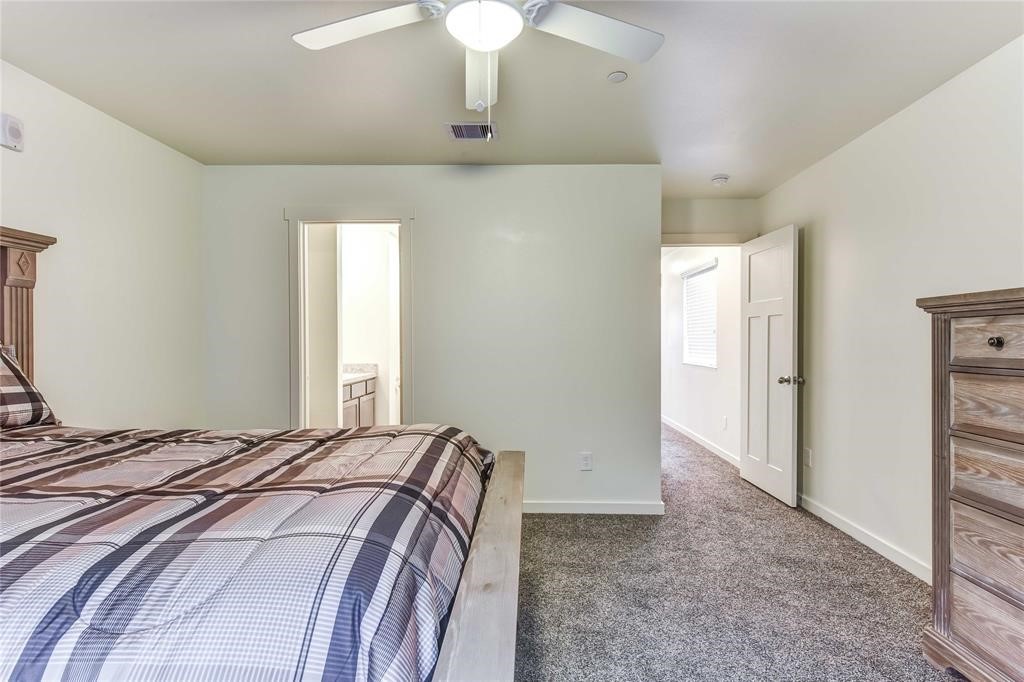 21155 Gosling Road, Unit 37 Spring, TX 77388 - Photo 7 of 11 a bedroom with a bed and a chandelier