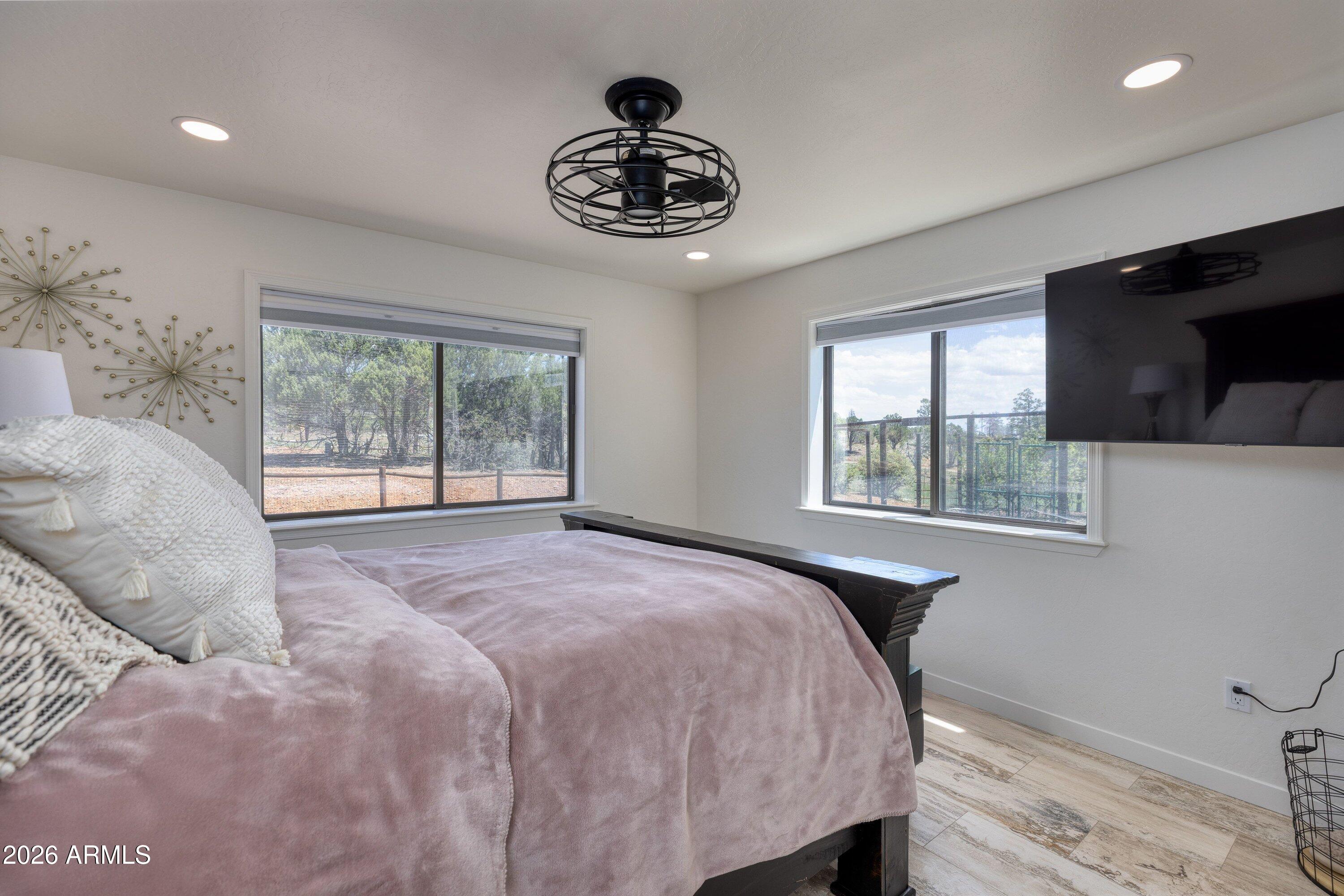 5182 Pinedale Wash Road Pinedale, AZ 85934 - Photo 26 of 54 a bedroom with a bed and a large window