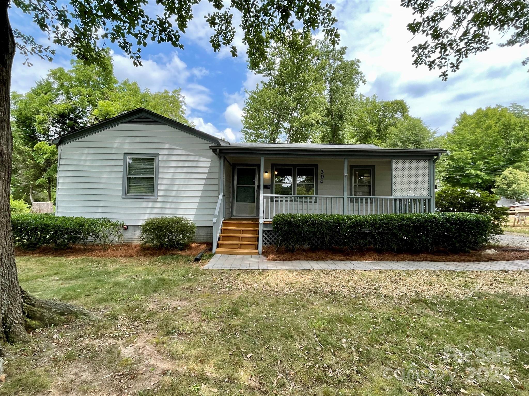 a view of house with backyard space and garden