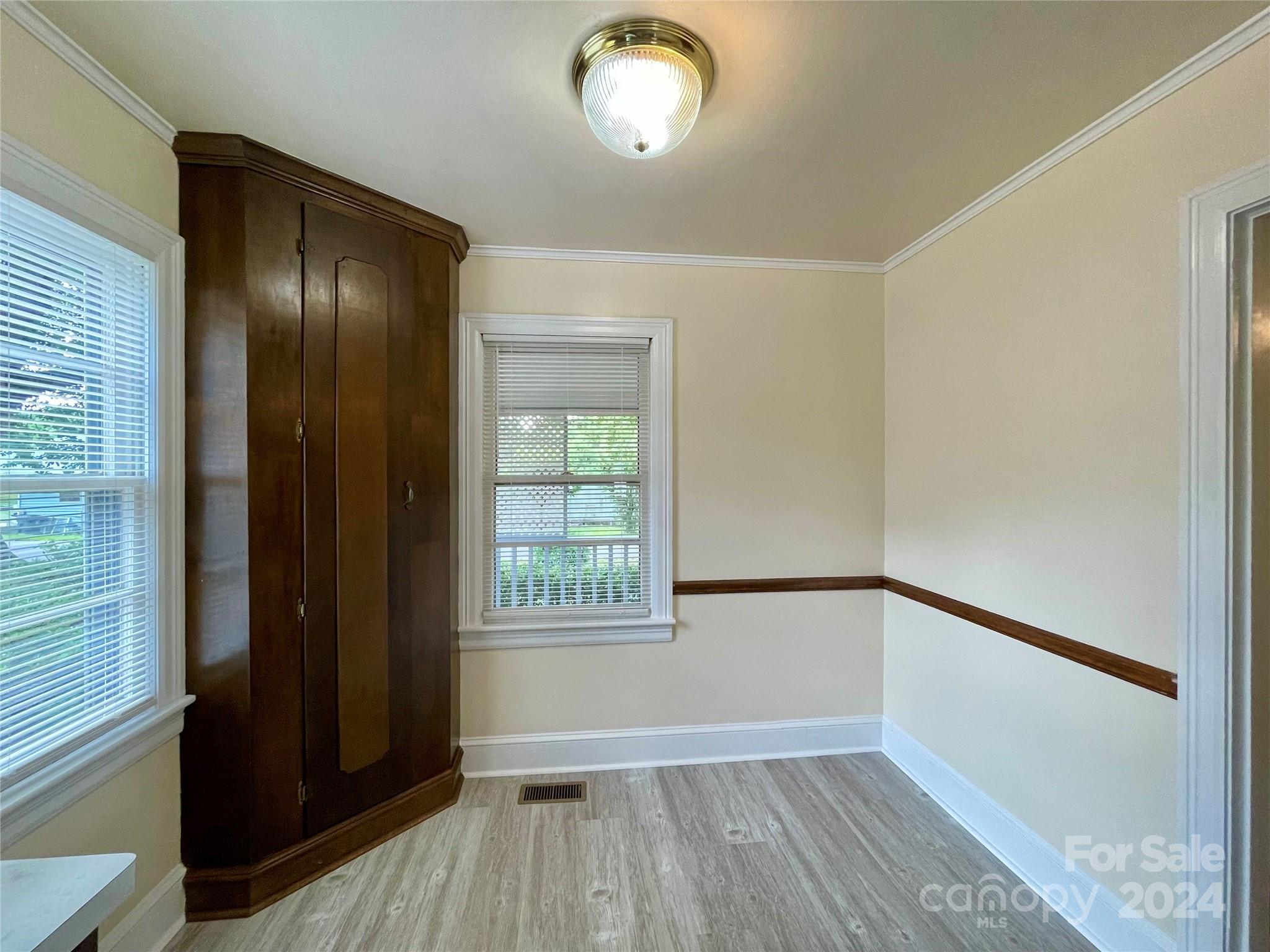 304 Rhyne Street Stanley, NC 28164 - Photo 12 of 38 a view of an empty room with wooden floor and a window