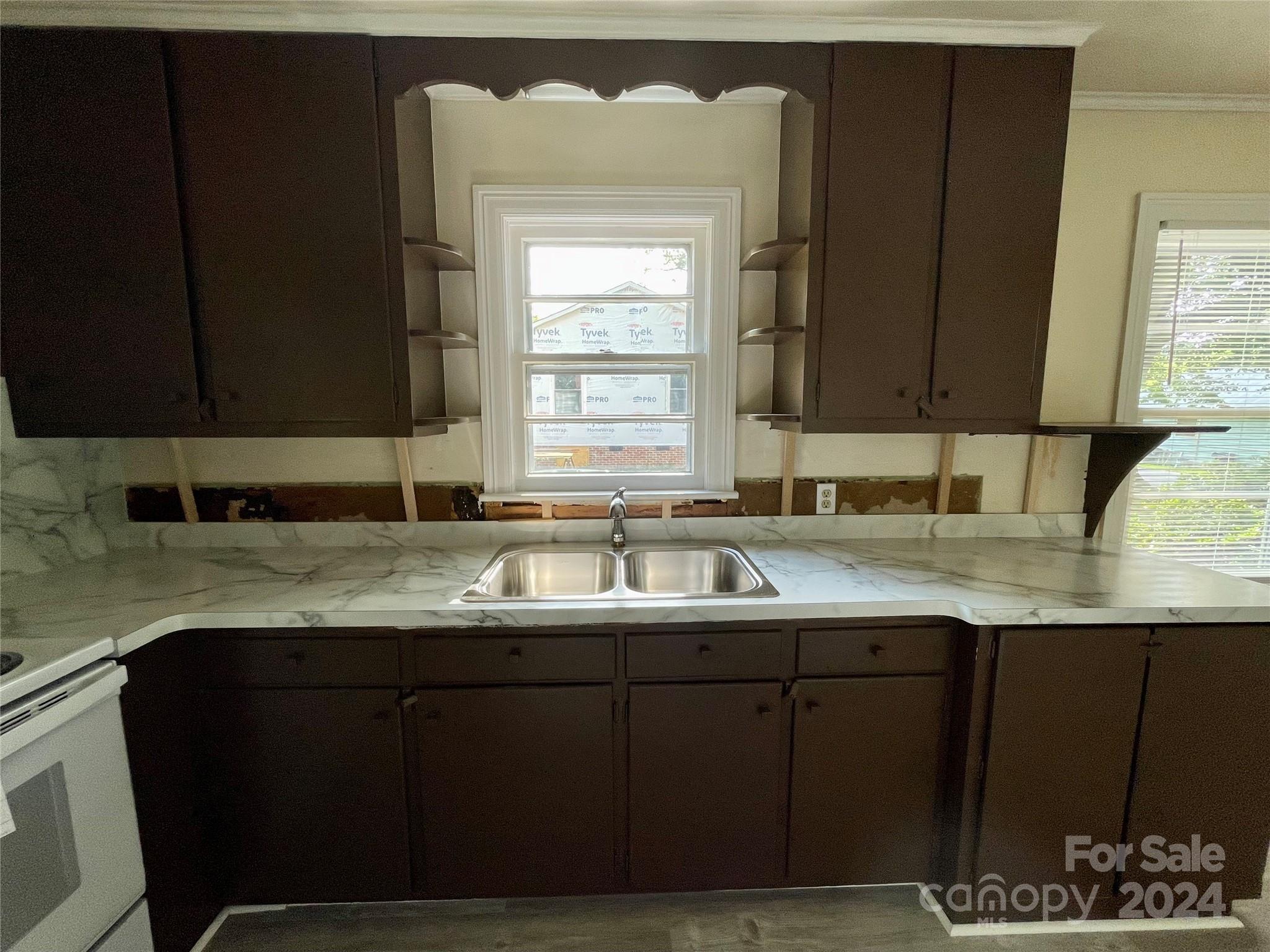 304 Rhyne Street Stanley, NC 28164 - Photo 15 of 38 a kitchen with a sink a window and cabinets