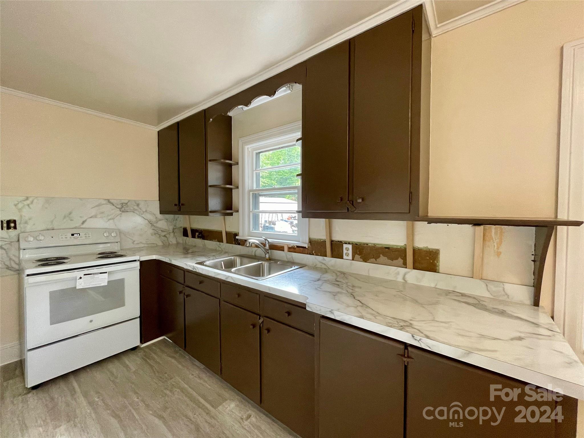 304 Rhyne Street Stanley, NC 28164 - Photo 16 of 38 a kitchen with a sink and cabinets