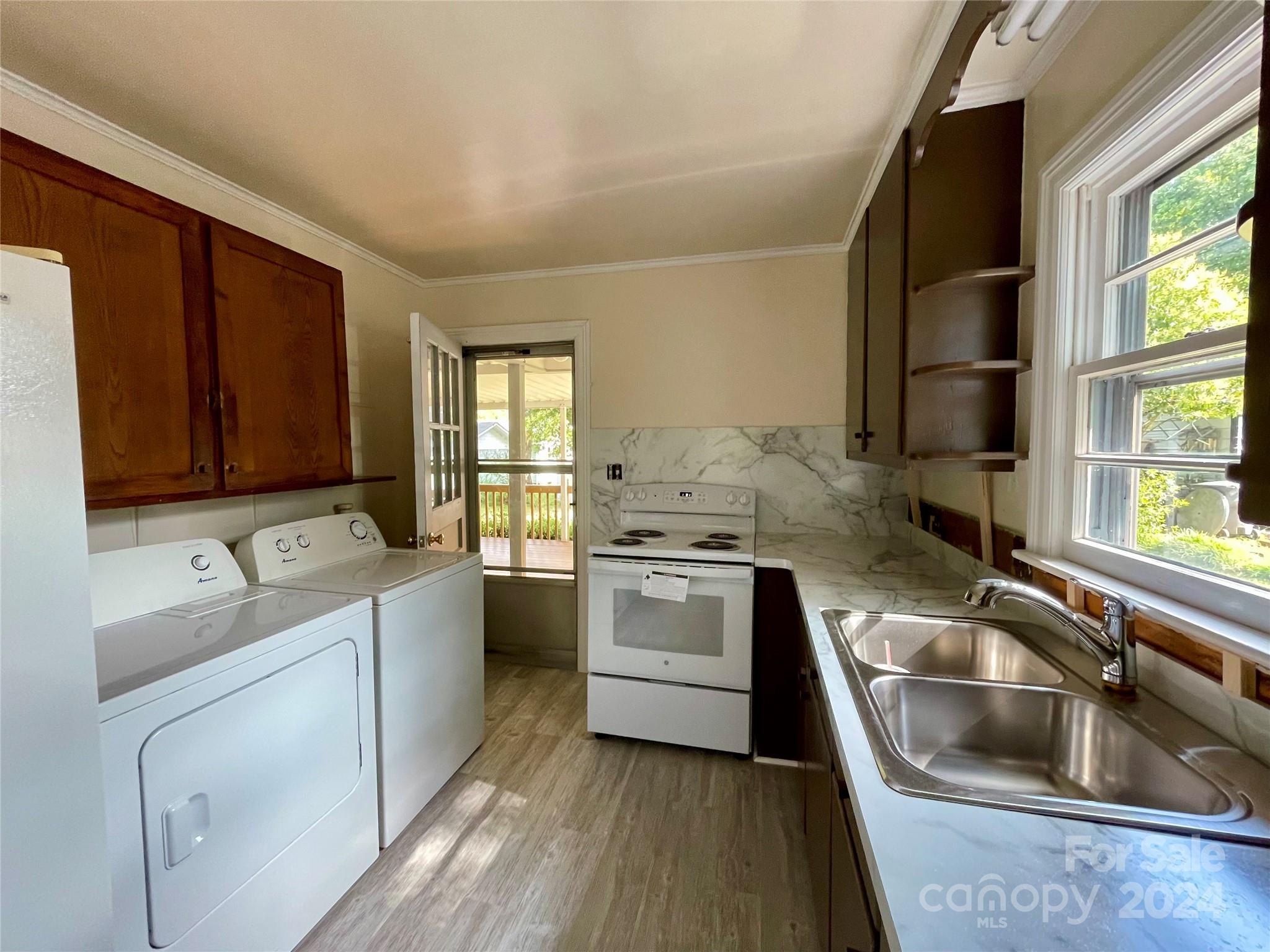304 Rhyne Street Stanley, NC 28164 - Photo 17 of 38 a kitchen that has a sink and a stove in it