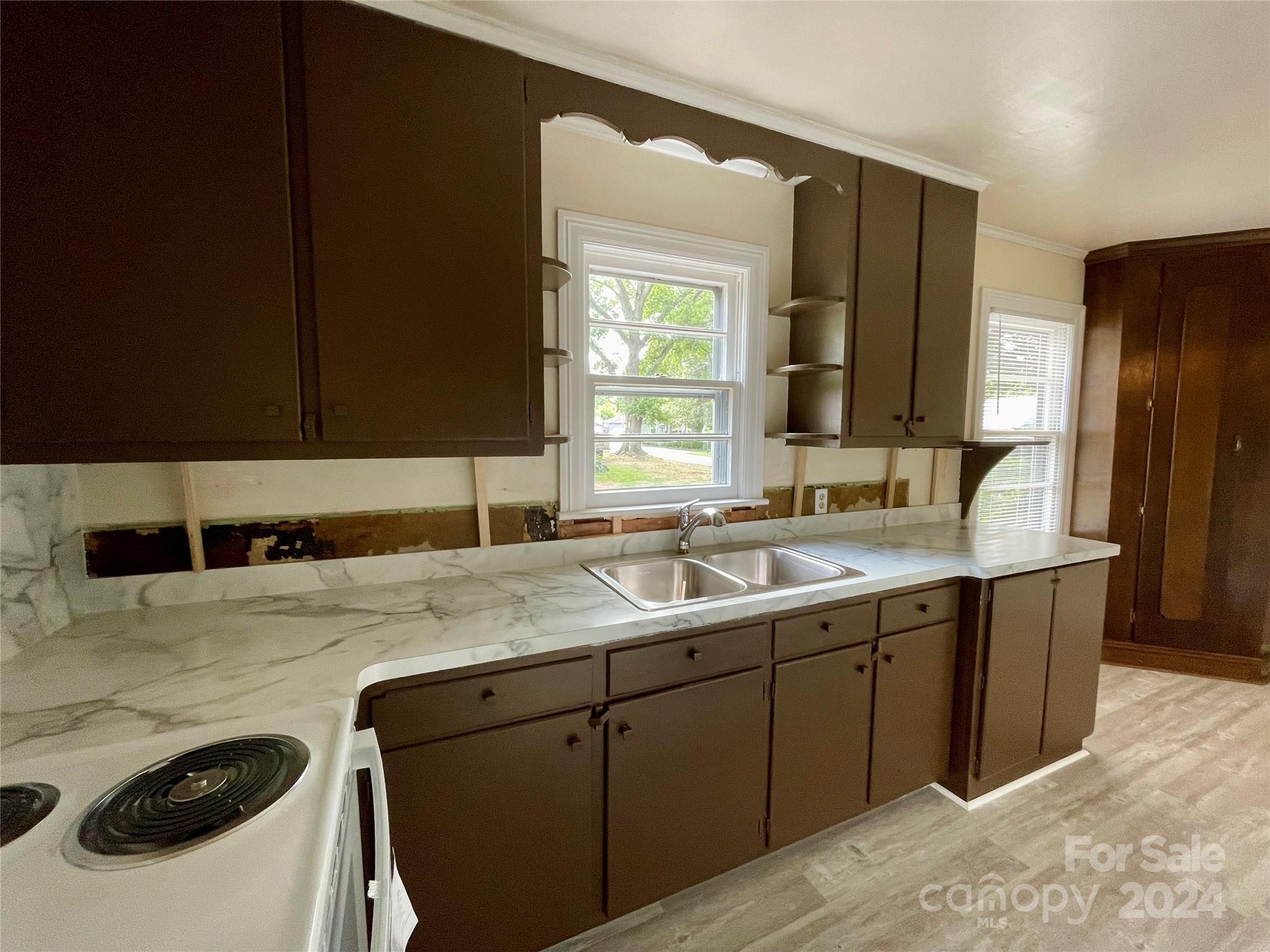 304 Rhyne Street Stanley, NC 28164 - Photo 18 of 38 a kitchen with a sink and a refrigerator