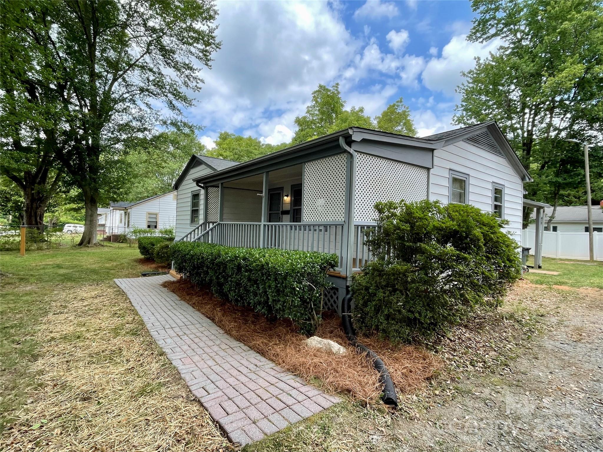 304 Rhyne Street Stanley, NC 28164 - Photo 25 of 38 a front view of house with yard and trees around