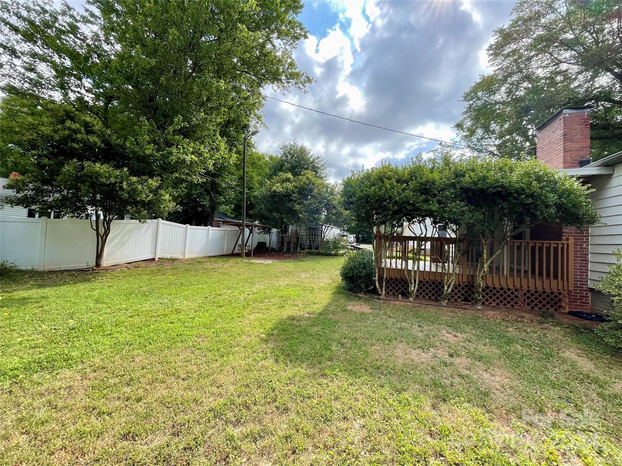 304 Rhyne Street Stanley, NC 28164 - Photo 26 of 38 a view of a backyard with a garden and trees