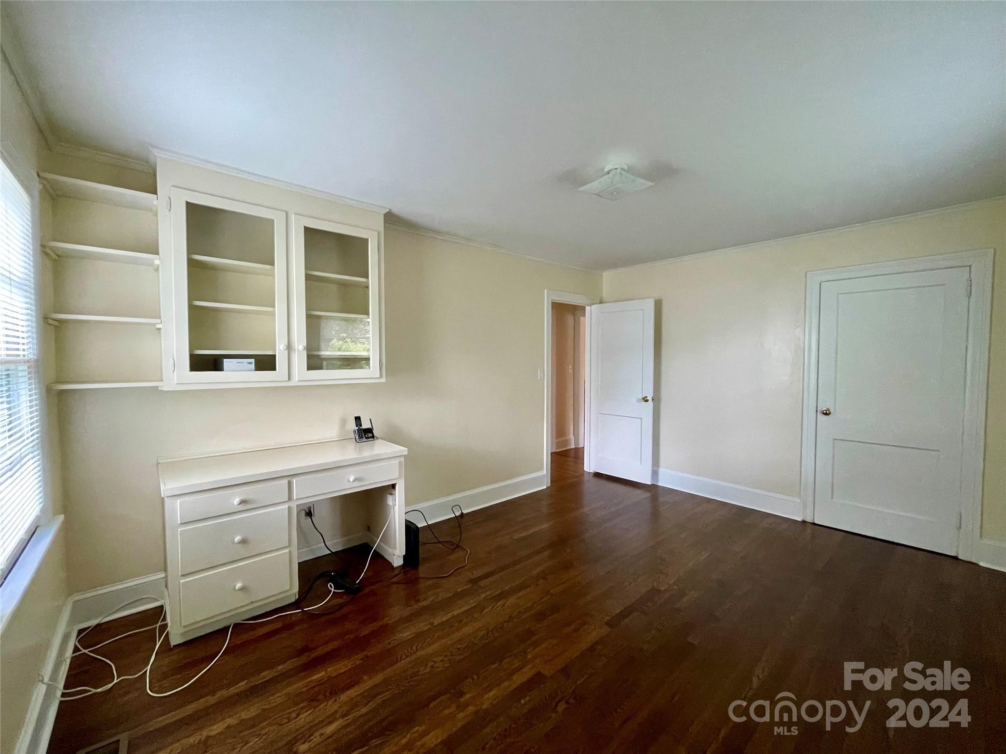 304 Rhyne Street Stanley, NC 28164 - Photo 31 of 38 an empty room with a wooden floor and windows