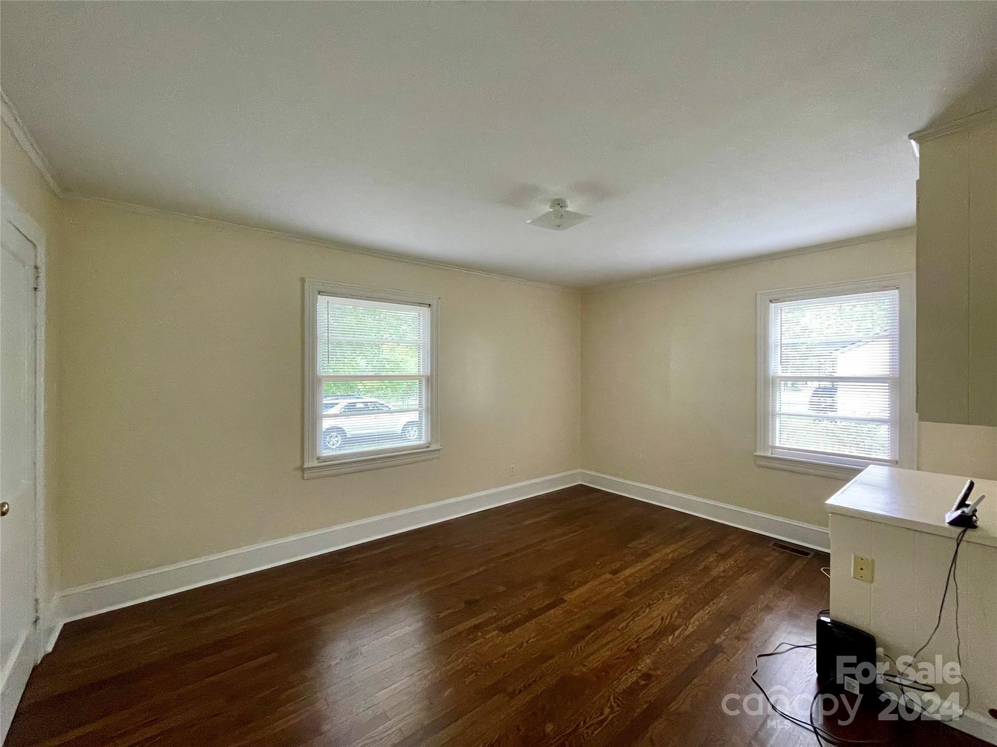 304 Rhyne Street Stanley, NC 28164 - Photo 32 of 38 a view of an empty room with wooden floor and a window