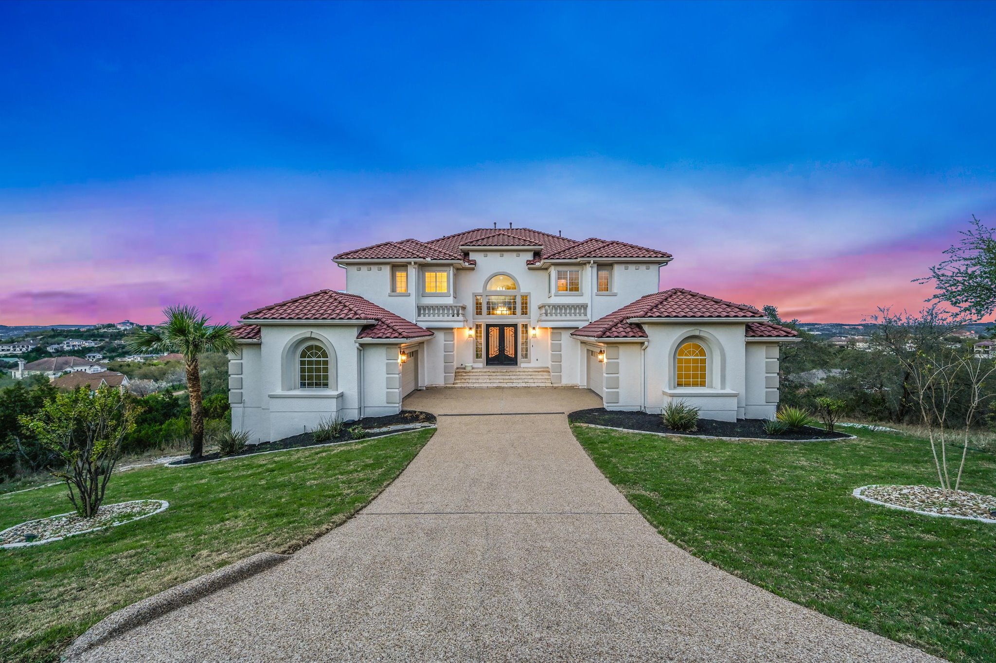 4319 Rum Runner Road Austin, TX 78734 - Photo 2 of 40 Mediterranean / spanish-style home with stucco siding, concrete driveway, a front yard, and a tile roof