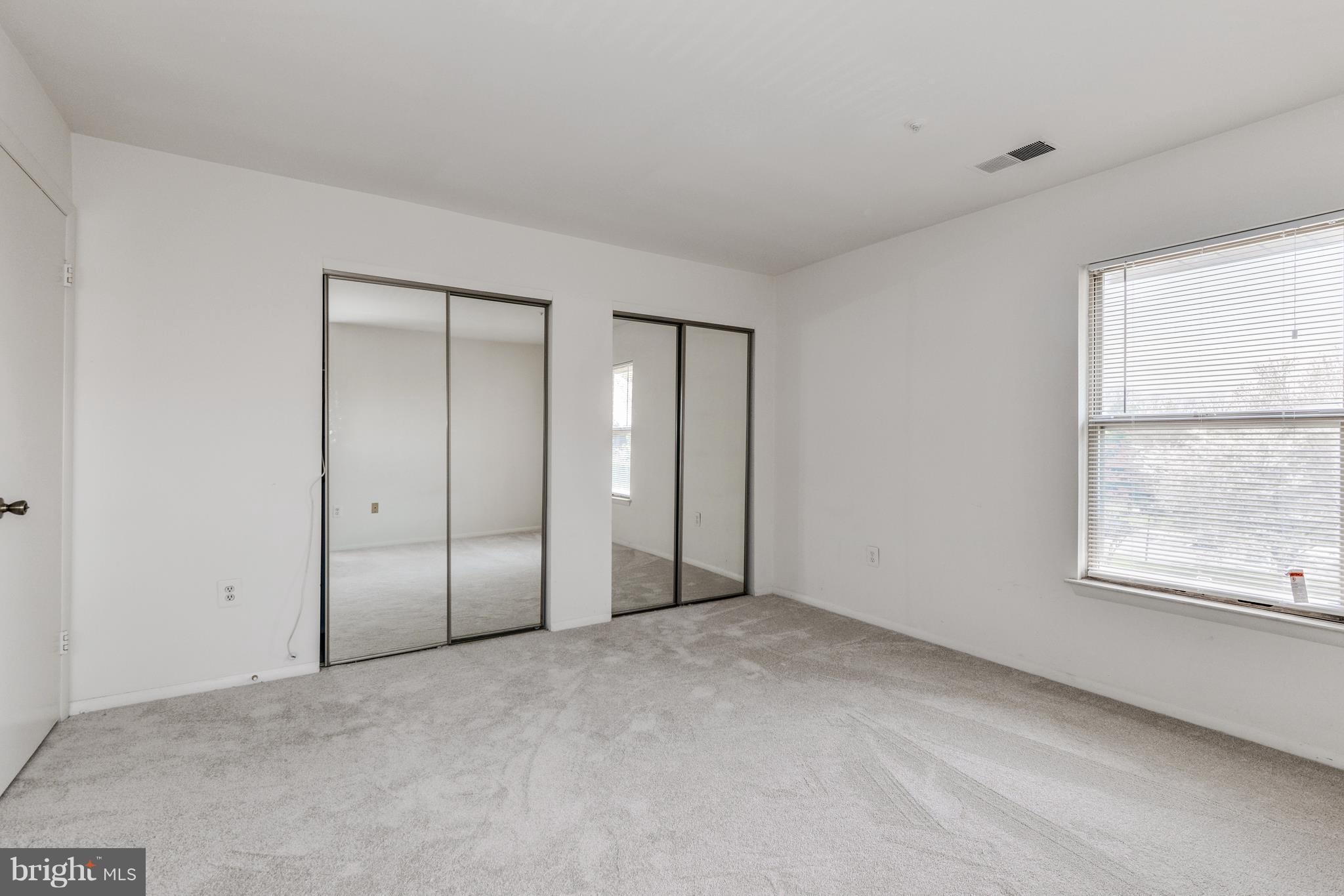 7804 Guildberry Court, Unit 303 Gaithersburg, MD 20879 - Photo 15 of 21 an empty room with a empty space and windows